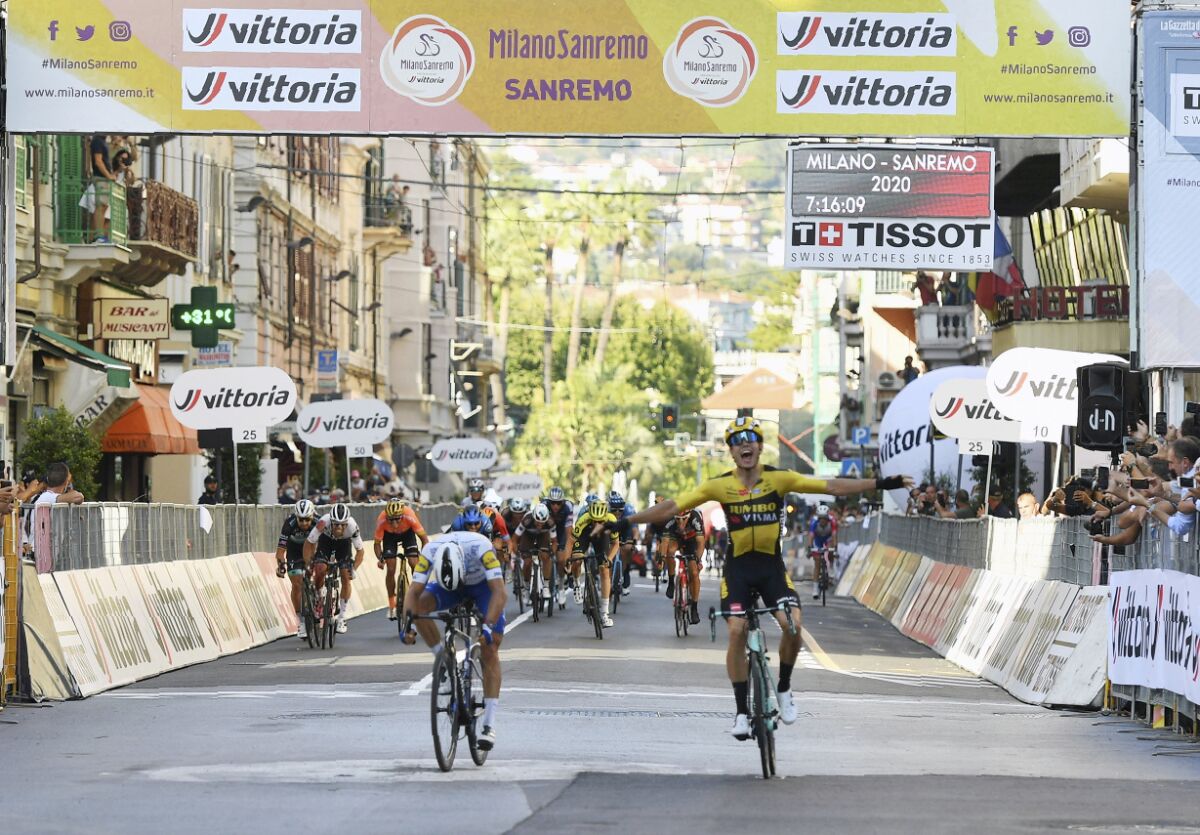 Belgium's Wout Van Aert, right, sprints ahead of France's Julian Alaphilippe to win the Milan to Sanremo cycling race, in San Remo, Italy, Saturday, Aug. 8, 2020. (Gian Mattia D'Alberto/LaPresse via AP)