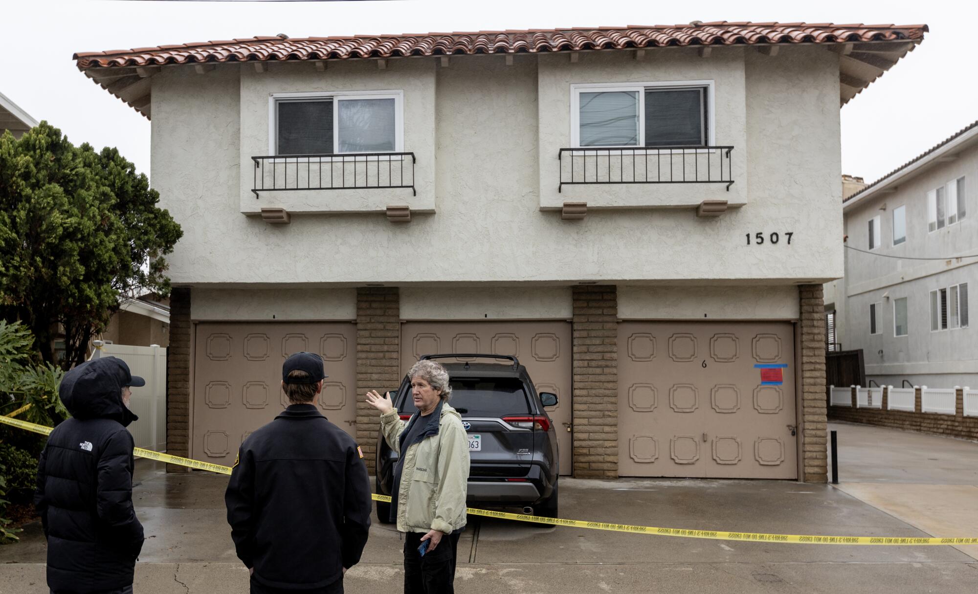 Officials help evacuate people from one of four cliff-side, ocean-view apartment buildings that were tagged