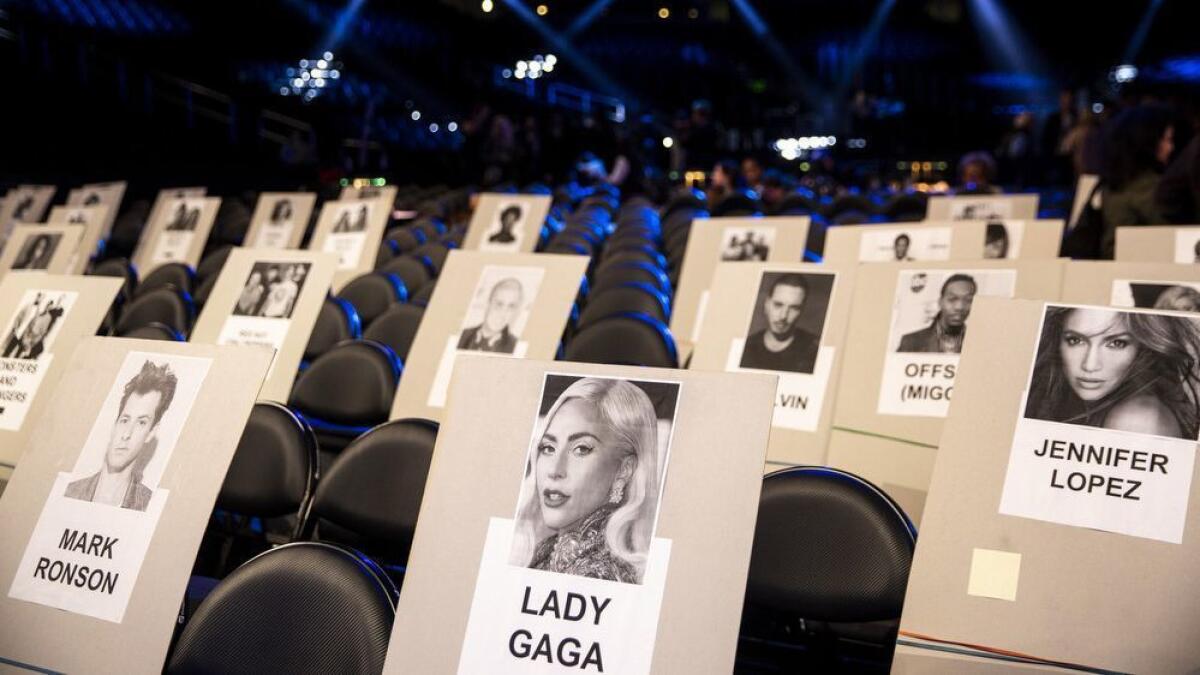 Placement cards for Mark Ronson, Lady Gaga, Jennifer Lopez and other attendees mark their seating positions while Brandi Carlile rehearses for the 61st Annual Grammy Awards show at Staples Center on Thursday.