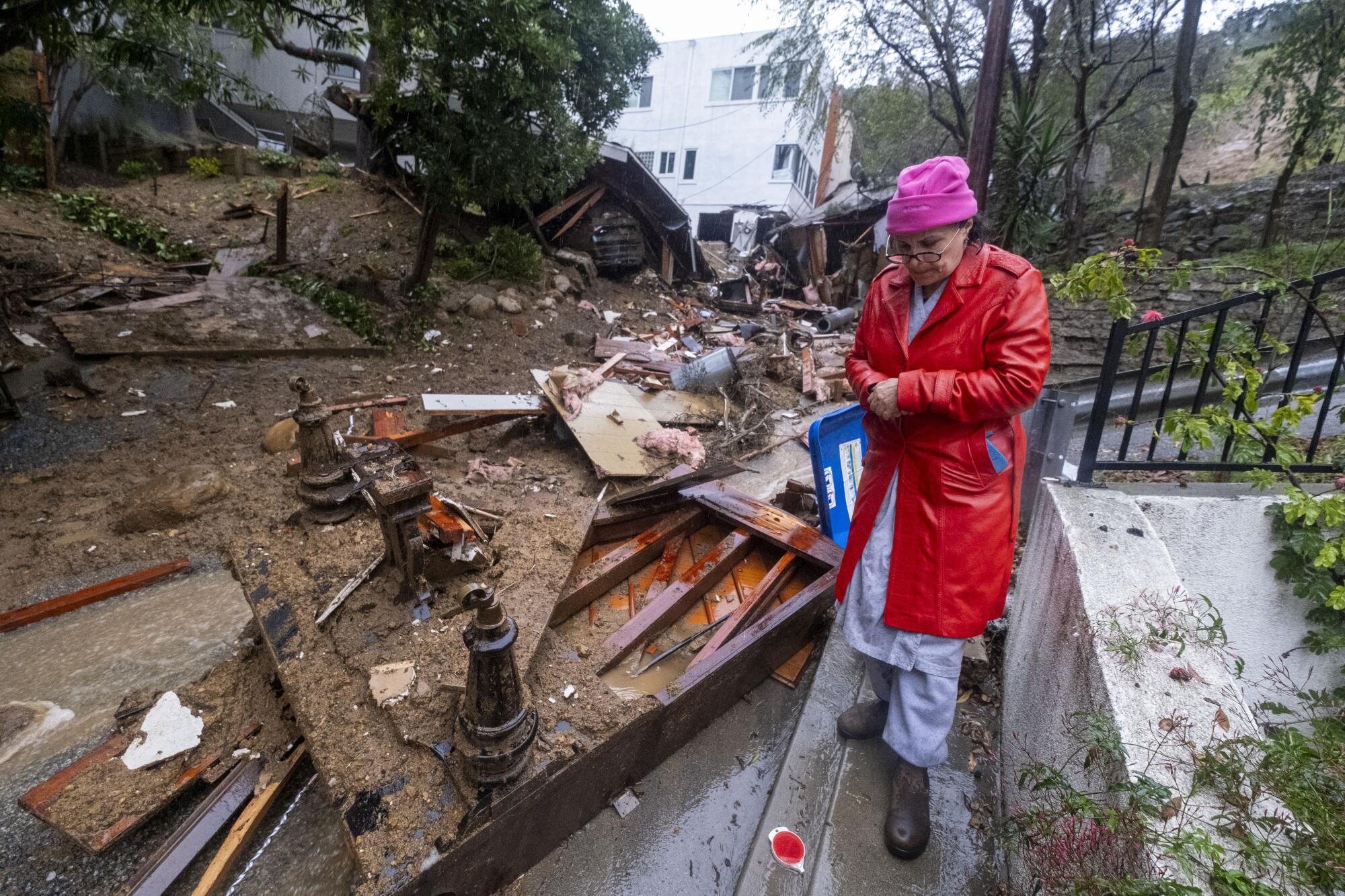 A resident walks by a destroyed home.