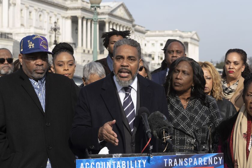 Congressional Black Caucus Chairman Rep. Steven Horsford, D-Nev., center, speaks with reporters about police reform while flanked by RowVaughn Wells, right, mother of Tyre Nichols, who died after being beaten by Memphis police officers, and her husband Rodney Wells, left, on Capitol Hill in Washington, Tuesday, Feb. 7, 2023. (AP Photo/Cliff Owen)
