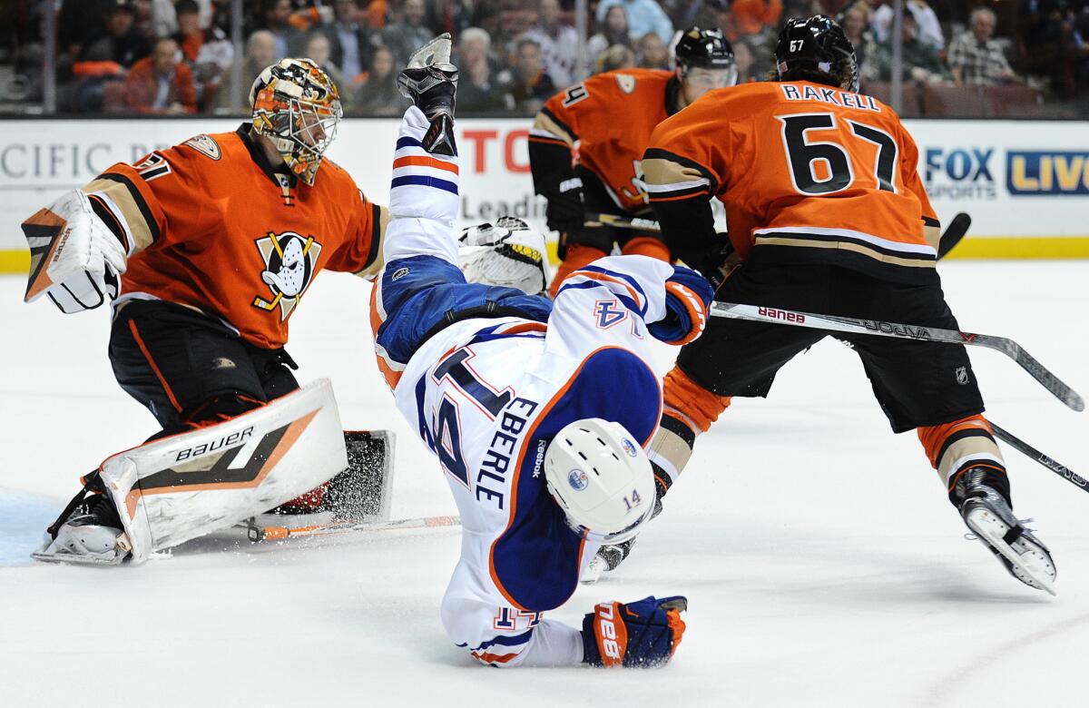 Oilers right wing Jordan Eberle is upended as he skates through the crease against the Ducks on Wednesday night.