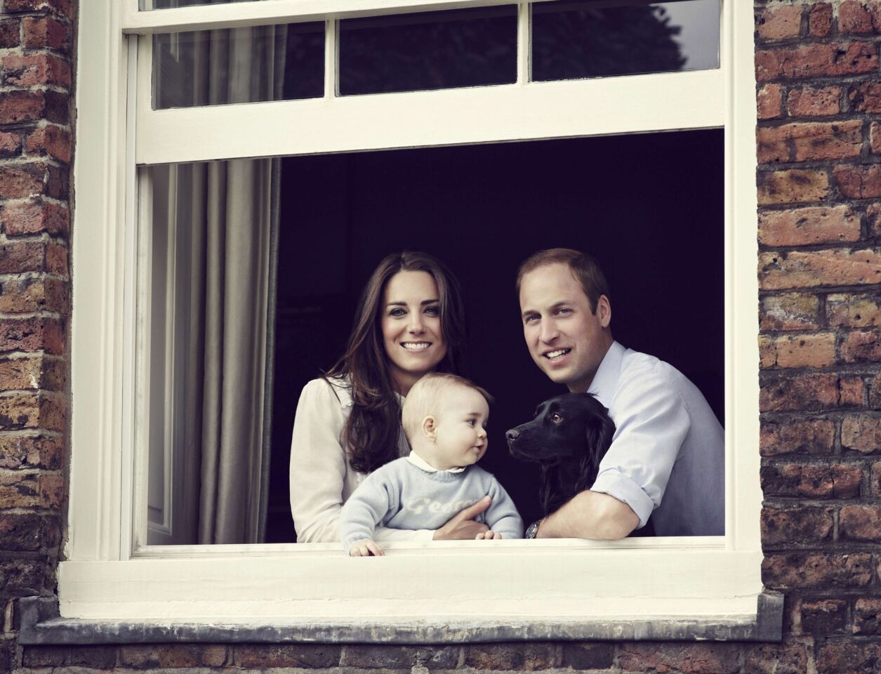 Prince William, Duke of Cambridge, Catherine, Duchess of Cambridge and Prince George of Cambridge pose for an official family portrait at London's Kensington Palace, ahead of their tour to Australia and New Zealand, on March 18, 2014.