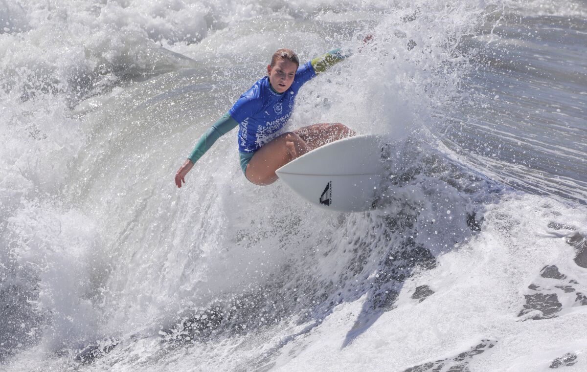 Surfer Tessa Thyssen of France competes in the first day of the Super Girl Surf Pro surf contest at the Oceanside Pier on Friday. She won the heat to advance. The event continues through Sunday.