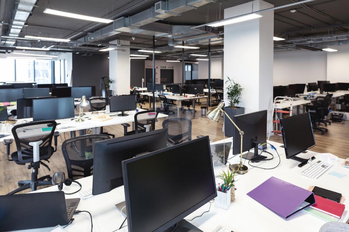 Computers sit in an empty office.