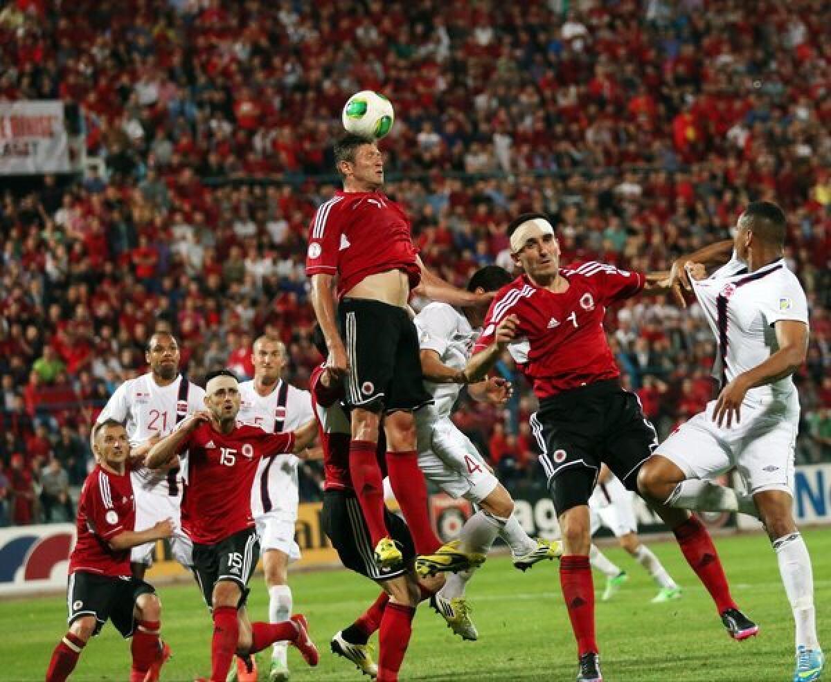 Edgar Cani of Albania heads the ball during a World Cup qualifying match against Norway.