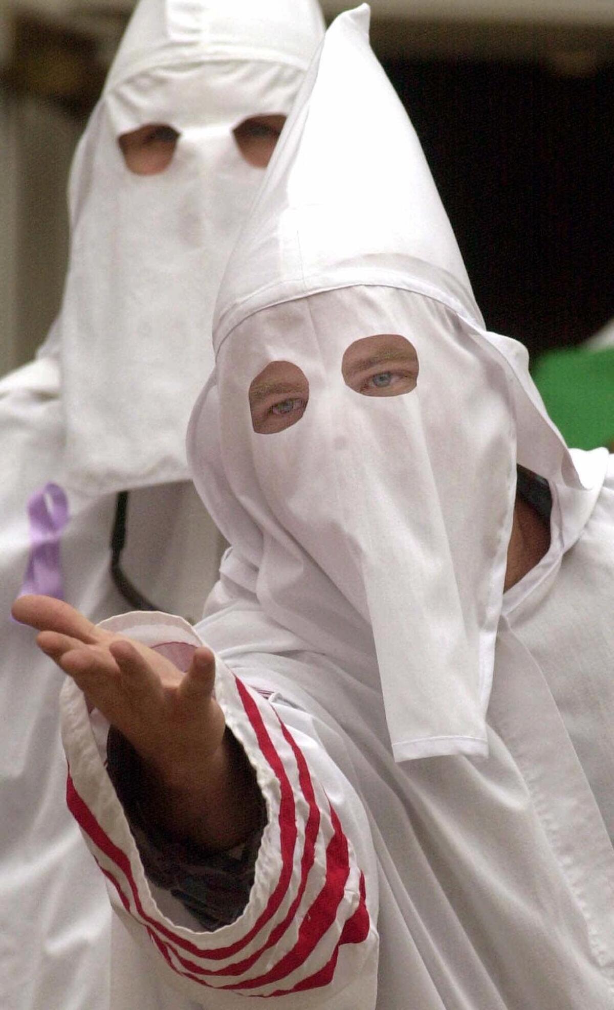 A hooded Ku Klux Klan member taunts the crowd during a rally in 2000 in downtown Carlisle, Pa. The Southern Poverty Law Center reported that such hate groups were in decline in 2013.
