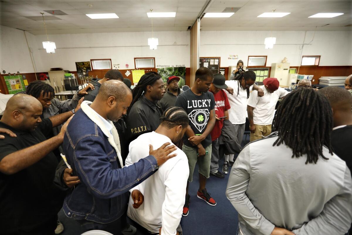 Gang leaders bow in prayer to conclude the peace summit. Like the truces of the early 1990s, the current peace movement appears to be largely confined to L.A.-area black gangs.