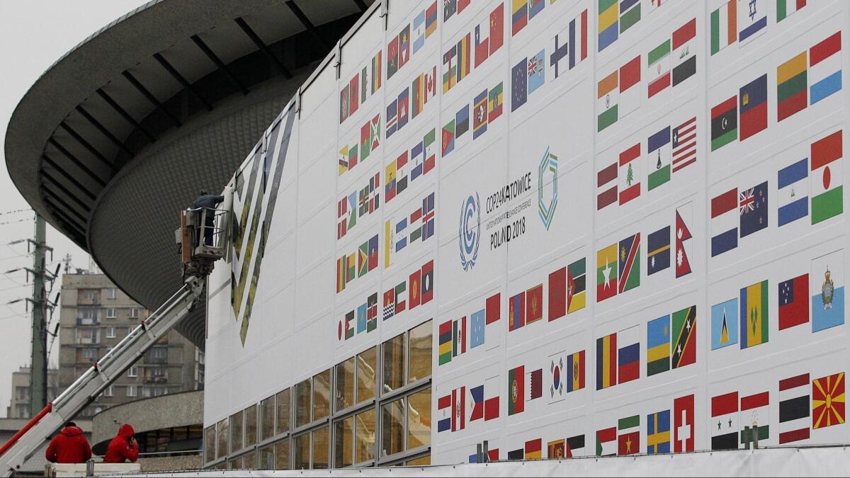 Workers decorate the venue of a global climate summit to be held at the site of a closed coal mine in the city of Katowice in southern Poland, where -- three years after forging the landmark Paris accord -- world leaders will meet to address reducing greenhouse gas emissions.