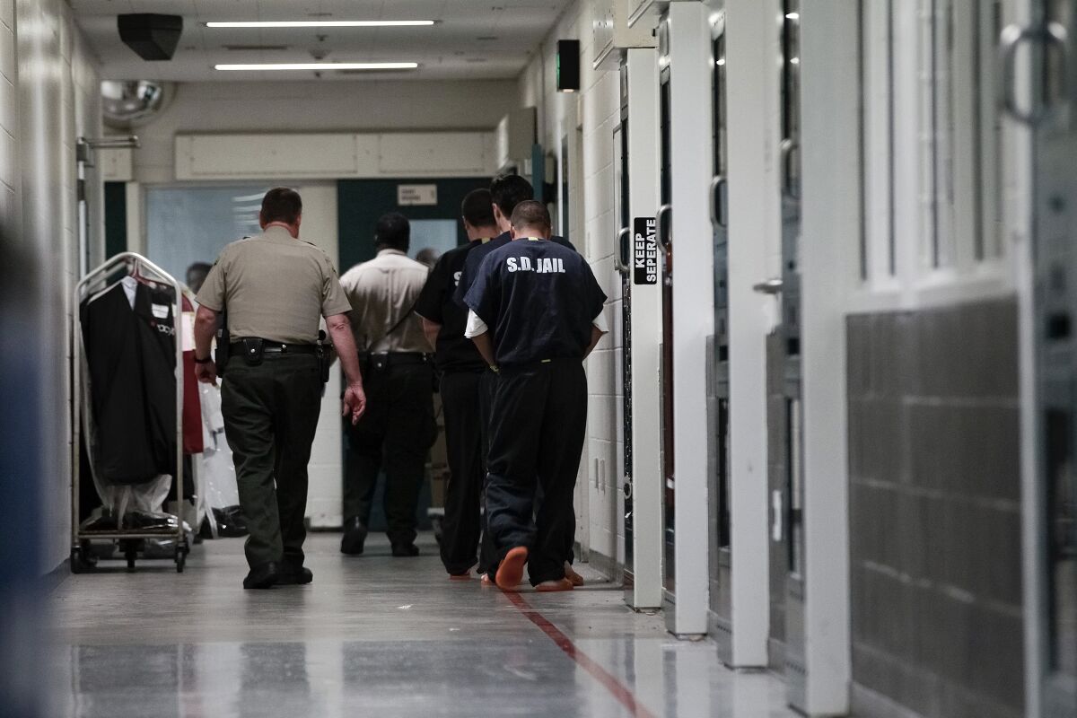 Sheriff's Deputies escorts inmates down a secured hallway at downtown Central Jail on Nov. 18, 2015, in San Diego. 