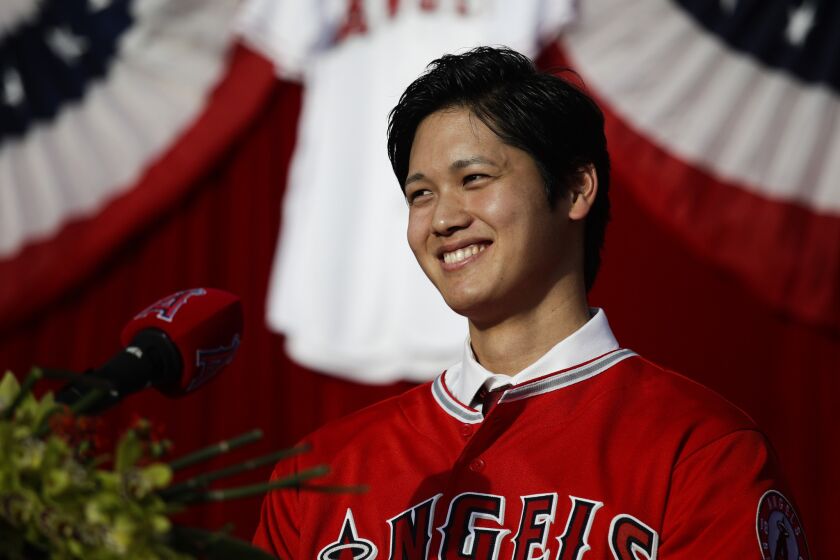 Baseball player Shohei Ohtani, from Japan, smiles during a news conference at Angel Stadium, Saturday, Dec. 9, 2017, in Anaheim, Calif. Ohtani, who intends to be both a starting pitcher and an everyday power hitter, turned down interest from every other big-league club to join two-time MVP Mike Trout and slugger Albert Pujols with the Angels, who are coming off their second consecutive losing season and haven't won a playoff game since 2009. (AP Photo/Jae C. Hong)