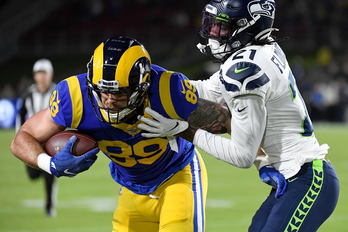 LOS ANGELES, CALIFORNIA - DECEMBER 08: Tight end Tyler Higbee #89 of the Los Angeles Rams carries the ball against the defense of cornerback Tre Flowers #21 of the Seattle Seahawks during the game at Los Angeles Memorial Coliseum on December 08, 2019 in Los Angeles, California. (Photo by Kevork Djansezian/Getty Images) ** OUTS - ELSENT, FPG, CM - OUTS * NM, PH, VA if sourced by CT, LA or MoD **