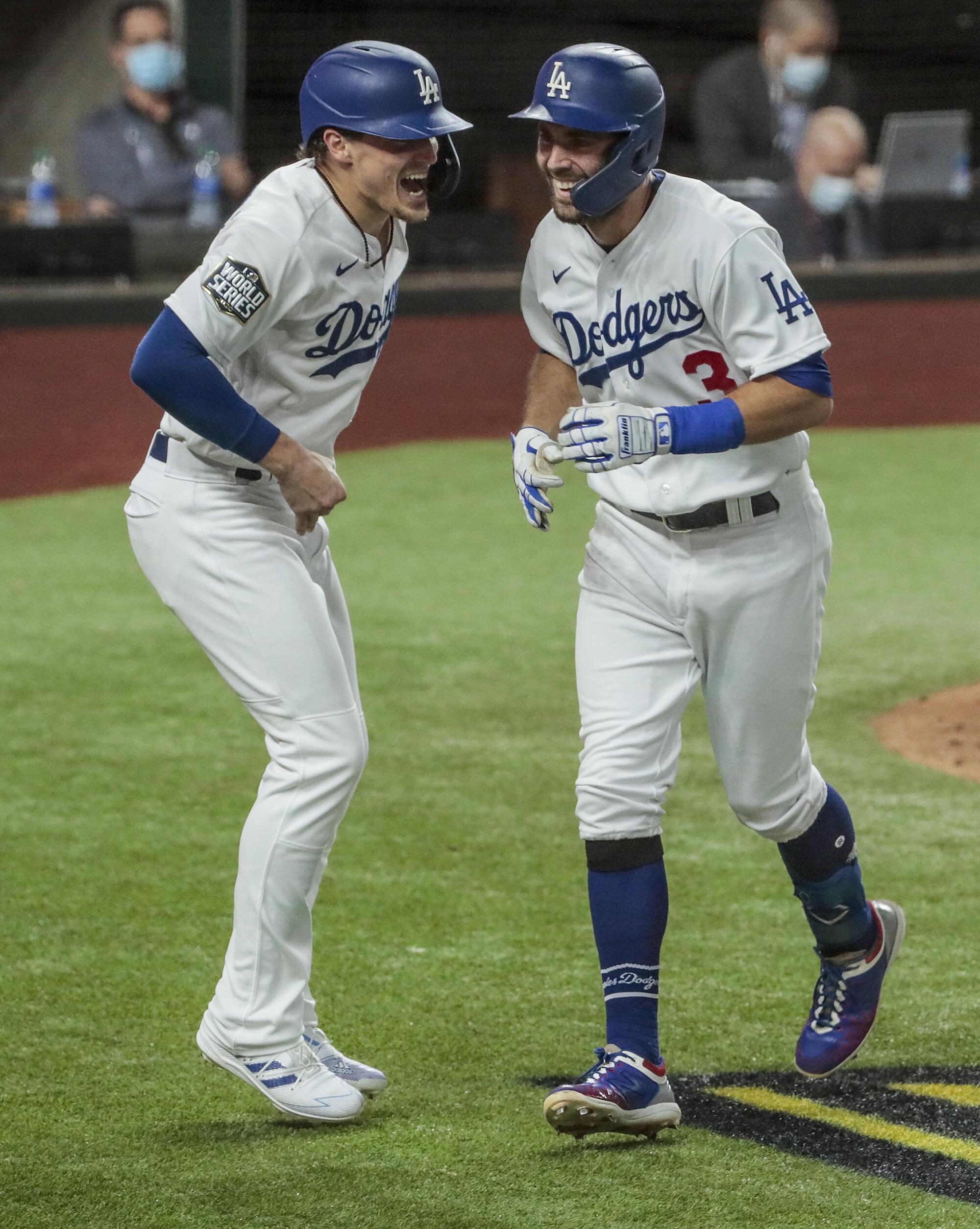 Dodgers second baseman Chris Taylor homers in the fifth inning and gets an earful from second baseman Kike Hernandez.
