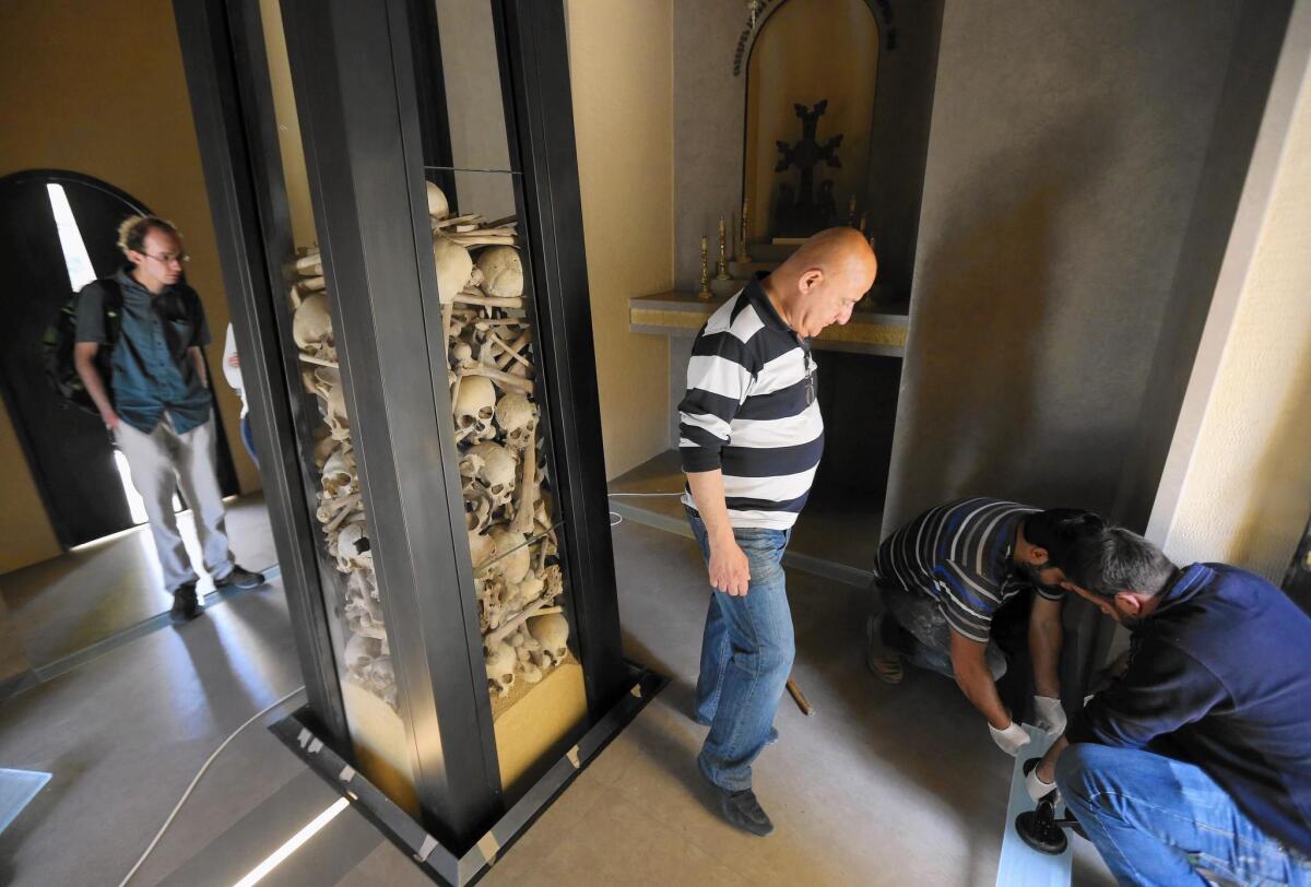 Visitors view the remains of Armenians killed under the Ottoman Empire, displayed at Saint Stephanos Church in Lebanon. The church is under renovation in preparation for the 100th anniversary of the genocide.