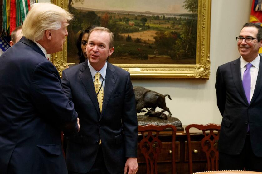 President Donald Trump talks with Budget Director Mick Mulvaney, center, and Treasury Secretary Steven Mnuchin during a meeting on the Federal budget, Wednesday, Feb. 22, 2017, in the Roosevelt Room of the White House in Washington. (AP Photo/Evan Vucci)