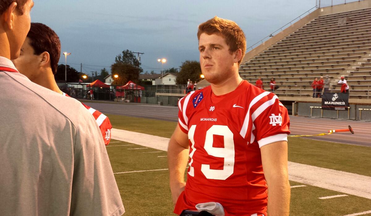Mater Dei quarterback Jack Lowary has a chat before warming up to play against Servite on Friday night.
