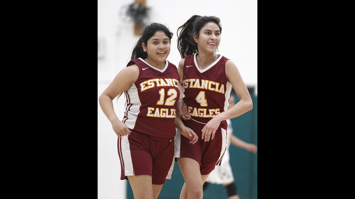 Estancia's Jennifer Leon and Wendy Santillan share a laugh as they come off the court during a game against Costa Mesa during a game on Tuesday, January 23.