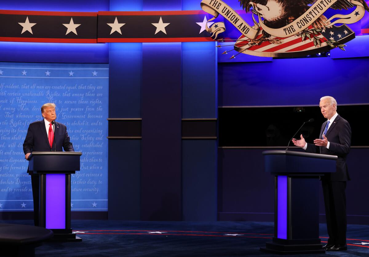 Donald Trump and Joe Biden debate under an image of a bald eagle carrying the banner "The Union and the Constitution Forever"