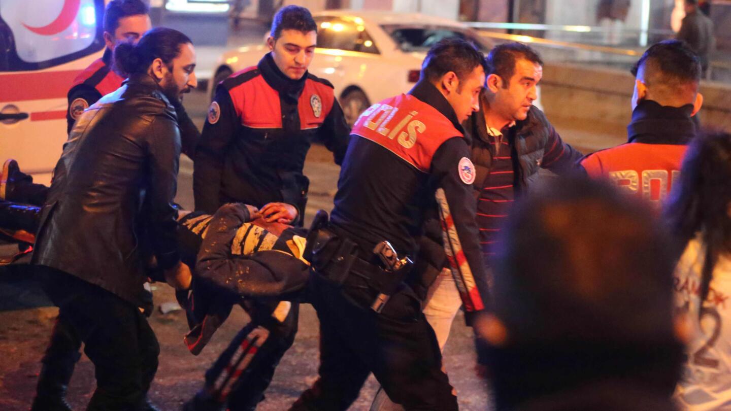 Rescuers carry a victim to an ambulance at the scene of a blast in Ankara, Turkey's capital, on Sunday. Dozens were killed and many more wounded, officials said.