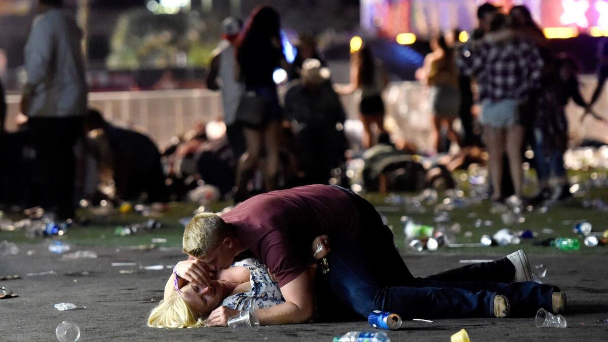 A man helps a woman at the Las Vegas festival. He got her up and they walked away together.