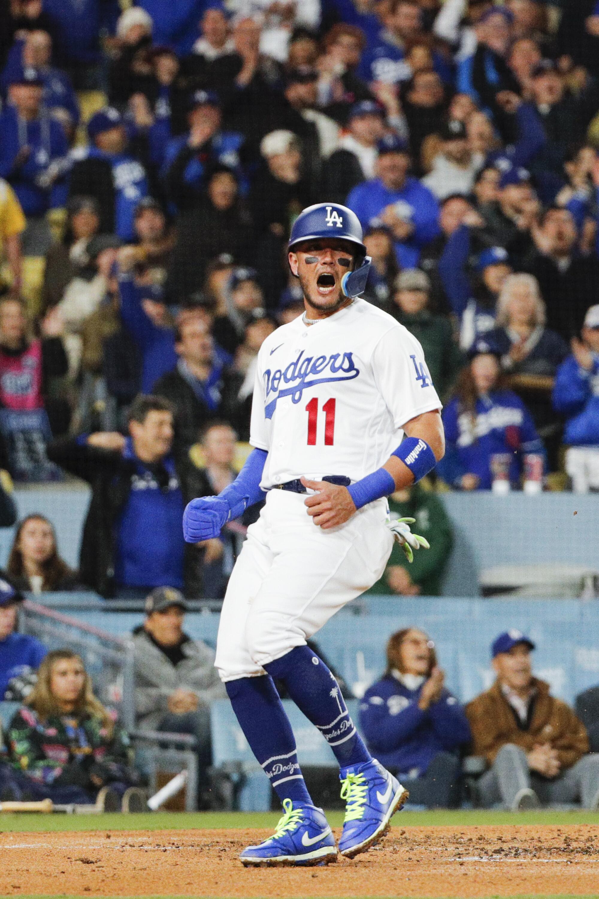 Miguel Rojas celebrates after scoring on a two-run double by Dodgers teammate Will Smith during the third inning.