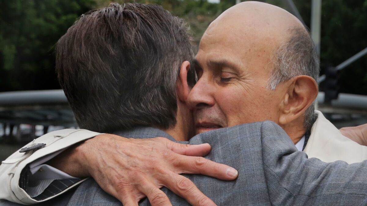 Former Los Angeles County Sheriff Lee Baca hugs his lawyer, Nathan Hochman, outside court last month.