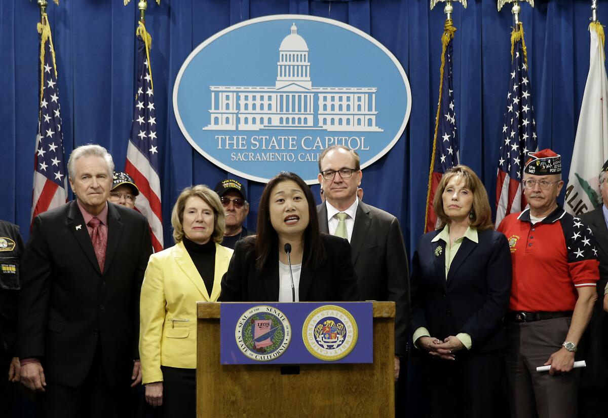 Accompanied by fellow GOP lawmakers and veterans in Sacramento on Monday, state Sen. Janet Nguyen (R-Garden Grove, center) announces a proposed constitutional amendment to block publicly funded universities from banning the American flag.