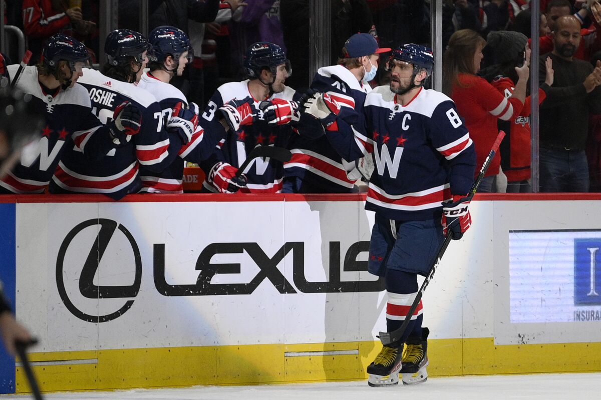 Washington Capitals left wing Alex Ovechkin (8) celebrates his goal during the second period of an NHL hockey game against the Columbus Blue Jackets, Saturday, Dec. 4, 2021, in Washington. (AP Photo/Nick Wass)