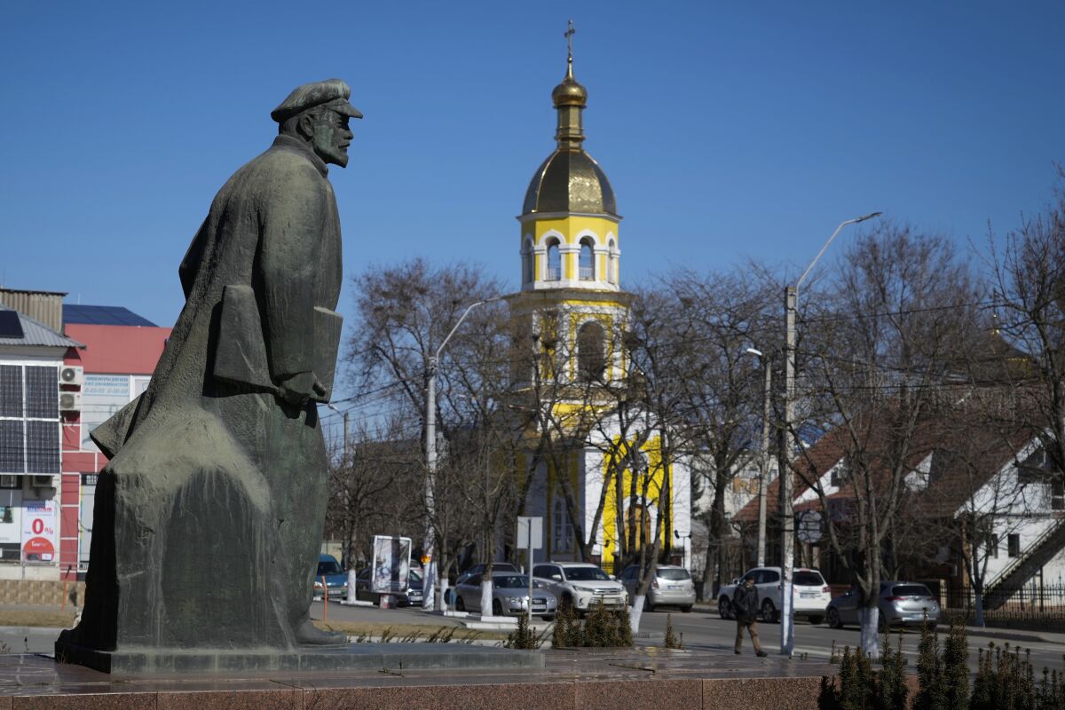The monument of Soviet founder Vladimir Lenin seen in the center of Comrat, Moldova, Saturday, March 12, 2022. Across the border from war-engulfed Ukraine, tiny, impoverished Moldova, an ex-Soviet republic now looking eagerly Westward, has watched with trepidation as the Russian invasion unfolds. In Gagauzia, a small, autonomous part of the country that's traditionally felt closer to the Kremlin than the West, people would normally back Russia, which they never wanted to leave when Moldova gained independence. (AP Photo/Sergei Grits)