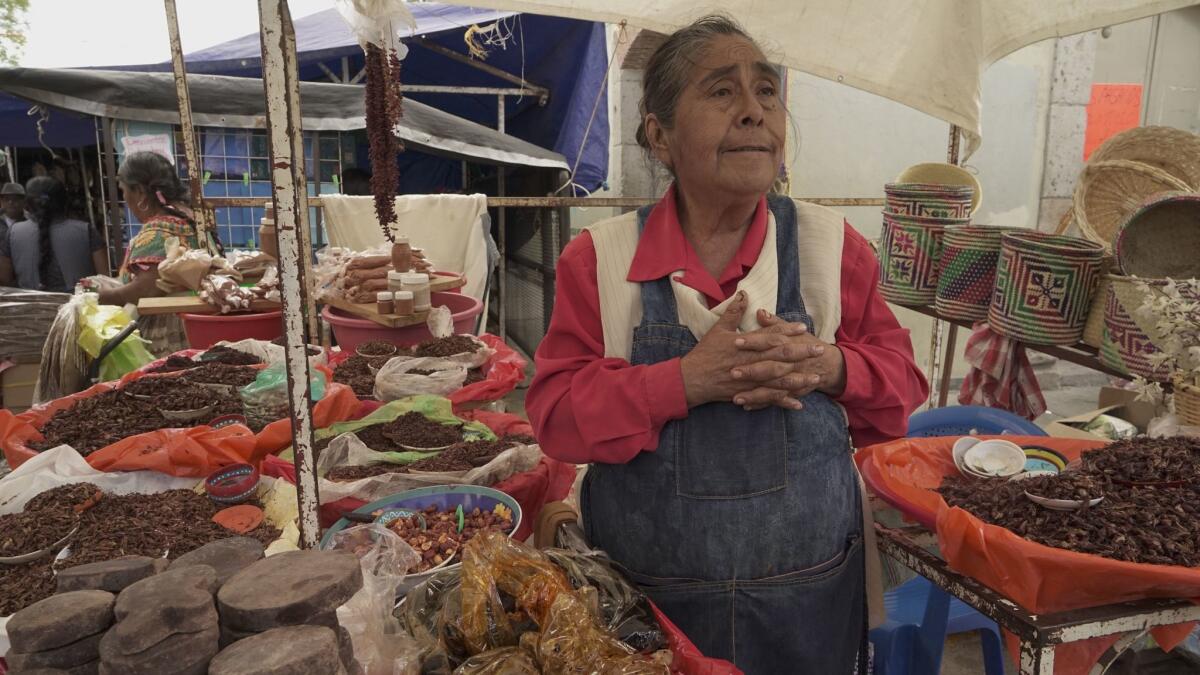 Eufenia Hernandez, 63, sells goods from her stall at the Sunday market in Tlacolula, Mexico.