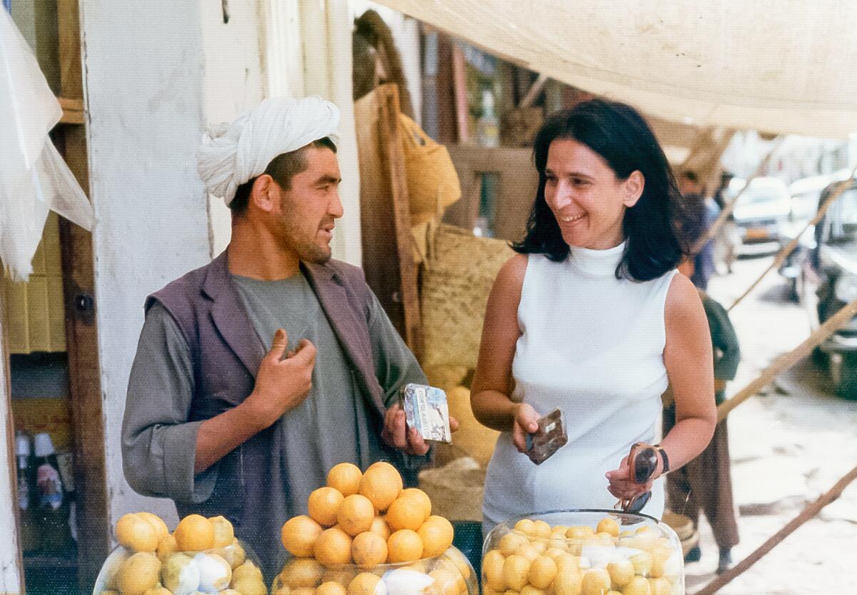 Author Julie Hill with a lemon vendor in Kabul in the early 1970s.
