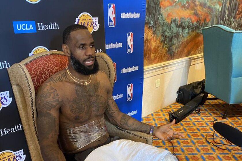 Lakers star LeBron James sits in an unusually ornate chair for his media session Tuesday.