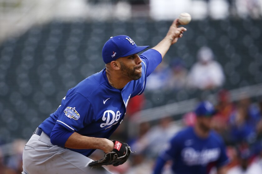 FILE - In this March 2, 2020, file photo, Los Angeles Dodgers starting pitcher David Price throws against the Cincinnati Reds during the first inning of a spring training baseball game in Goodyear, Ariz. Price will not play this season because of concerns over the coronavirus pandemic, delaying his Los Angeles debut until next year. The five-time All-Star became the latest player to opt out, posting Saturday, July 4, 2020, on Twitter that he would not participate in the 60-game season that is scheduled to begin July 23. (AP Photo/Ross D. Franklin, File)