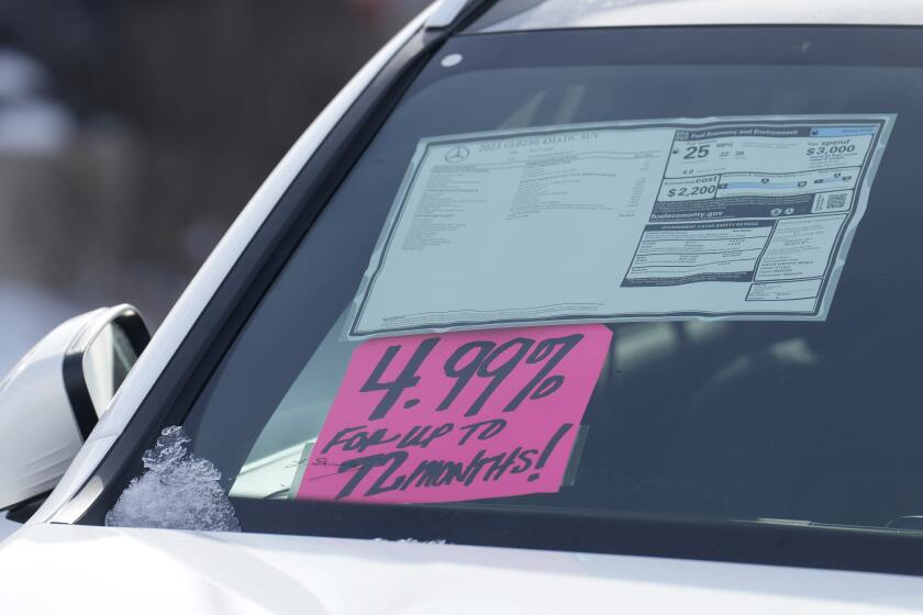 FILE - A sign highlighting the financing interest rate is displayed near the price sticker on an unsold 2023 vehicle at a Mercedes-Benz dealer on Nov. 30, 2023, in Loveland, Colo. The Federal Reserve’s decision Wednesday, May 1, 2024 to keep its benchmark rate at a two-decade high should have ripple effects across the economy. Mortgage rates, credit card rates, and auto loan rates will all likely maintain their highs, with consequences for consumer spending. (AP Photo/David Zalubowski, file)