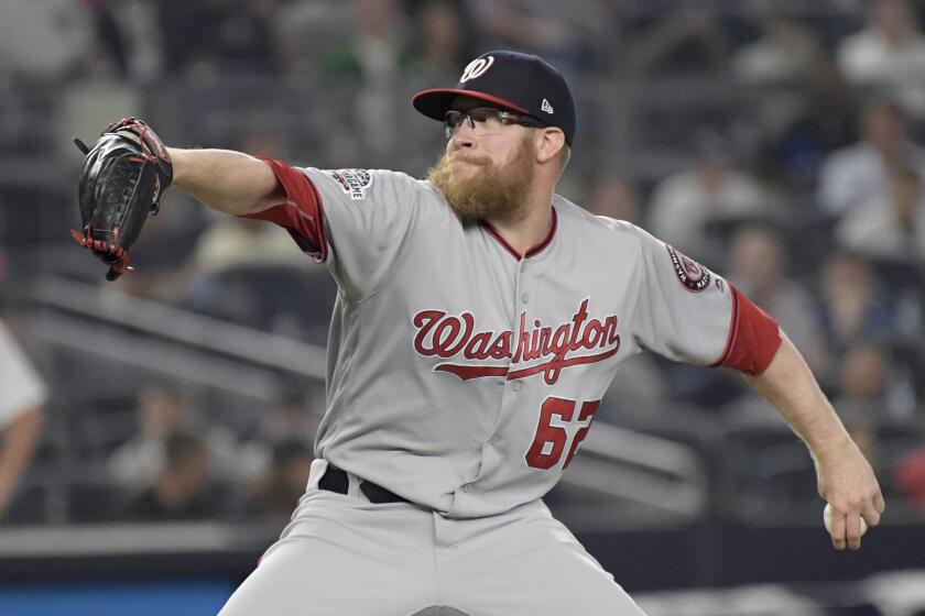 FILE - Washington Nationals relief pitcher Sean Doolittle delivers to the New York Yankees during the ninth inning of a baseball game at Yankee Stadium in New York, June 13, 2018. Sean Doolittle has decided to retire from baseball after more than a decade pitching in the majors that included helping the Washington Nationals win the World Series in 2019. Doolittle announced his decision in a lengthy social media post Friday, Sept. 22, 2023. (AP Photo/Bill Kostroun, File)