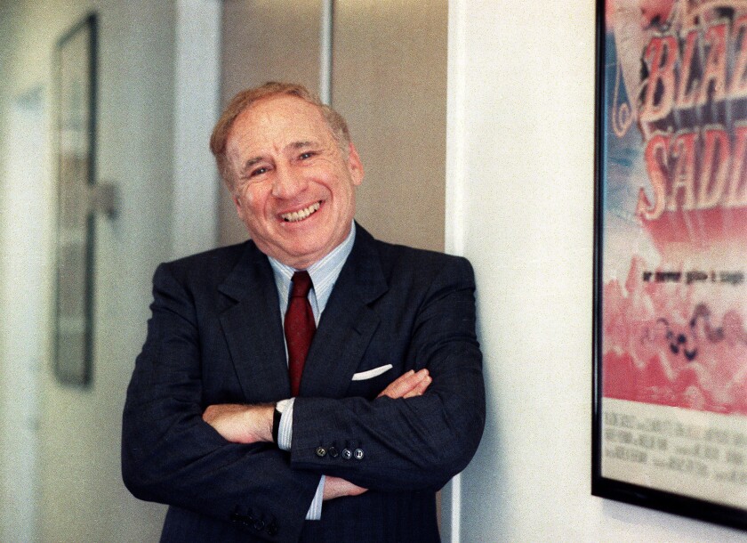 FILE - Actor-director-writer Mel Brooks poses next to a framed poster of his 1974 film "Blazing Saddles" in Los Angeles on July 23, 1991. Brooks released a memoir, "All About Me!: My Remarkable Life in Show Business." (AP Photo/Nick Ut, File)