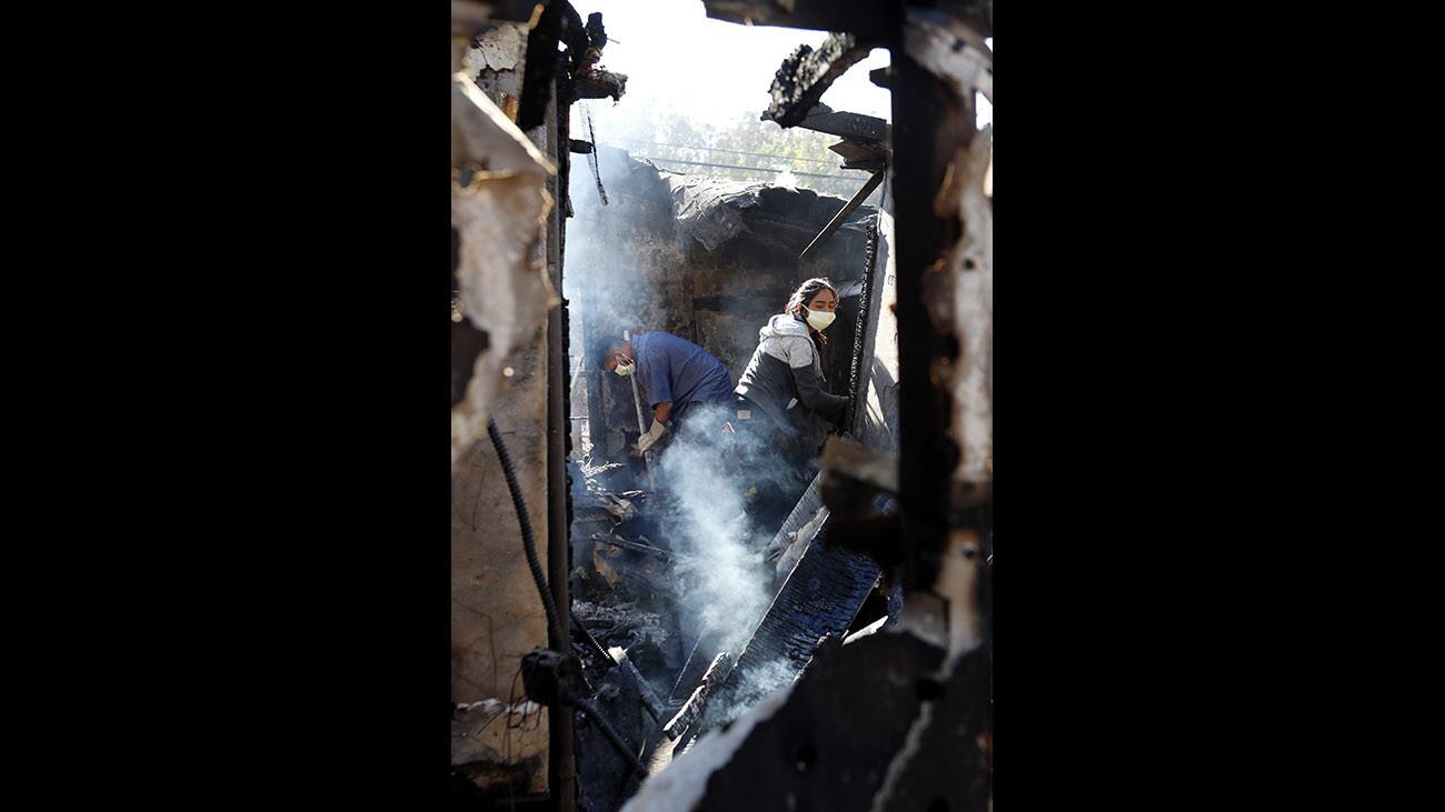 A day after the Creek Fire began and the home he lived at was destroyed, Trino Godinez, 25, and his sister Destinee Ramirez, 17, salvage what they can at 10763 Wheatland Ave., in Shadow Hills, on Wednesday, Dec. 6, 2017.