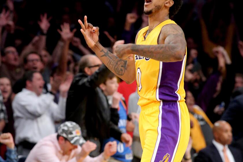 Guard Nick Young celebrates a three-point shot in the final seconds that pushed the Lakers ahead of the Thunder, 111-109, on Tuesday.
