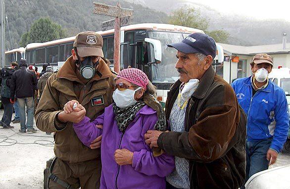 A woman is helped during the evacuation from Futaleufu, Chile.