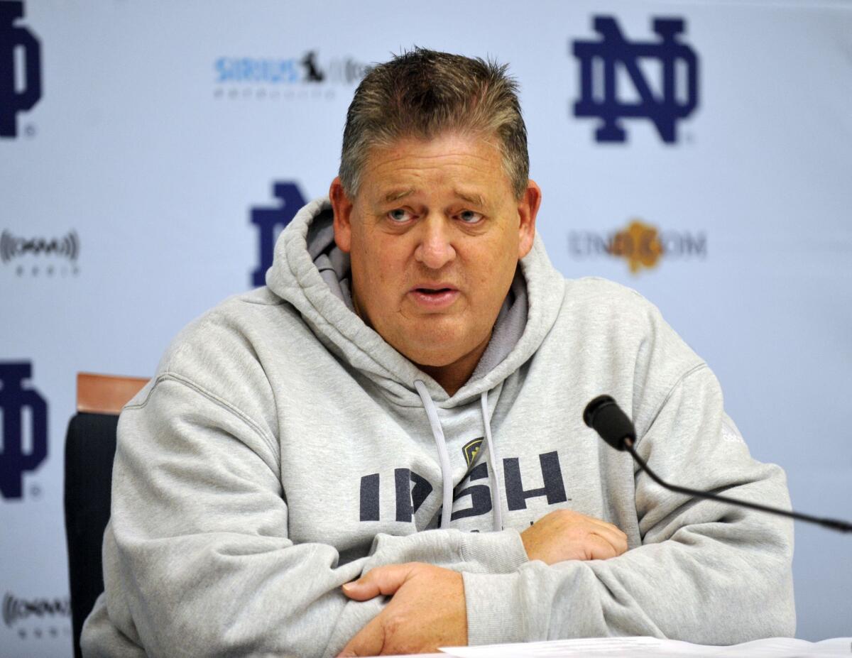 Then-Notre Dame football coach Charlie Weis answers questions during a news conference on Nov. 22, 2009.