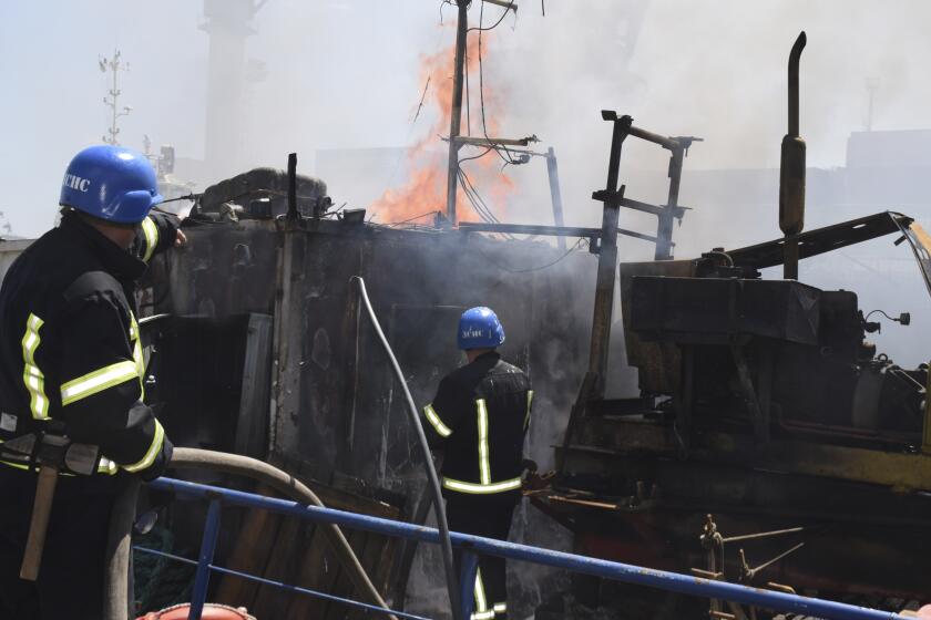 In this photo provided by the Odesa City Hall Press Office, firefighters put out a fire in a port after a Russian missiles attack in Odesa, Ukraine, Saturday, June 5, 2022. (Odesa City Hall Press Office via AP)