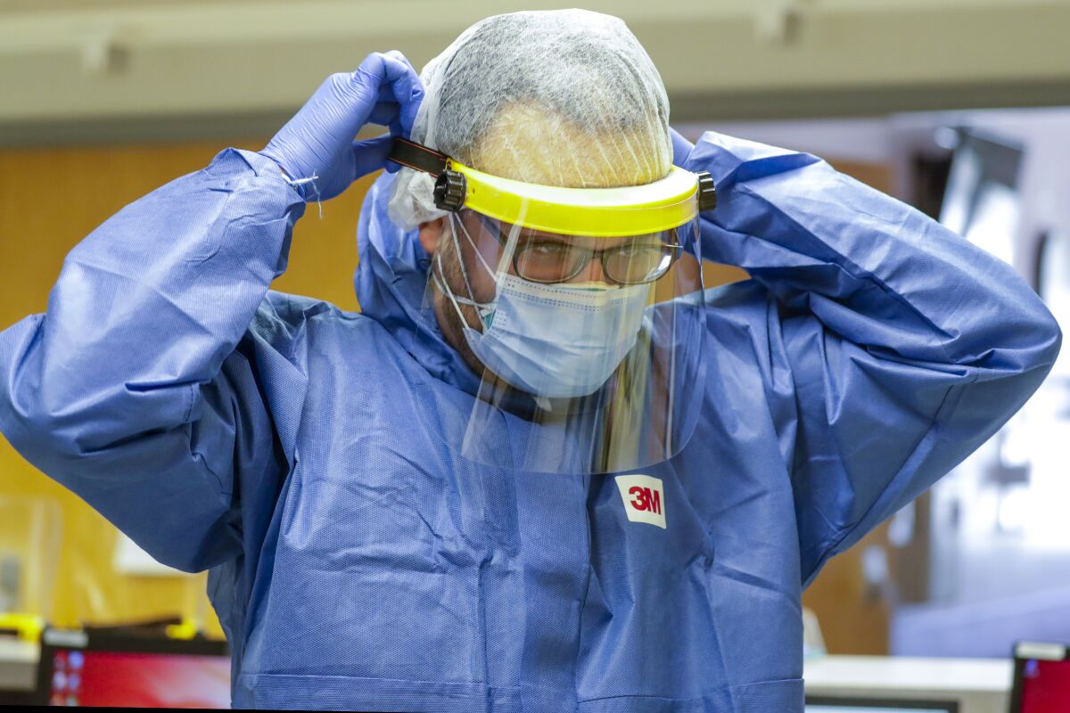Dr. Imran Siddiqui wears a face shield on the job at Desert Valley Medical Group in Victorville.