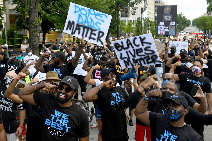 Members of the Dad Gang lead chants during a rally at Black Lives Matter Plaza in June in Washington, DC.