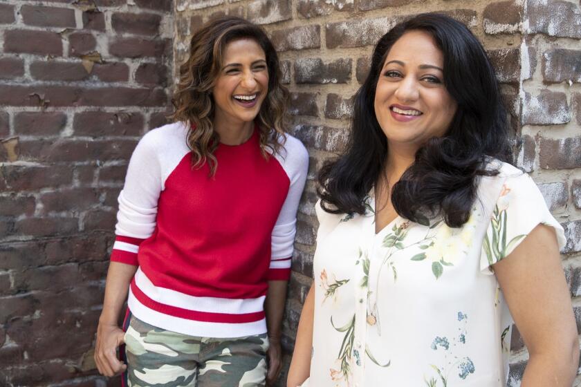 UNIVERSAL CITY, CALIF. -- THURSDAY, SEPTEMBER 6, 2018: Showrunner Aseem Batra, right, and actress Sarayu Blue, left, of the NBC sitcom 'I Feel Bad' pose for photographs on the Universal lot in Universal City, Calif., on Sept. 6, 2018. (Brian van der Brug / Los Angeles Times)