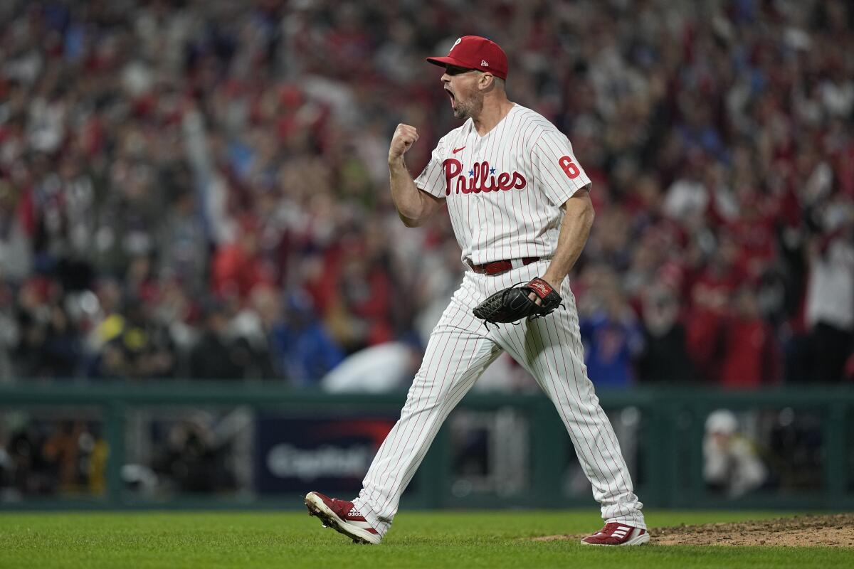 Philadelphia Phillies relief pitcher Andrew Bellatti celebrates their win in Game 3 of baseball's World Series between the Houston Astros and the Philadelphia Phillies on Tuesday, Nov. 1, 2022, in Philadelphia. The Phillies won 7-0 to take one game lead in the best of seven series. (AP Photo/David J. Phillip)