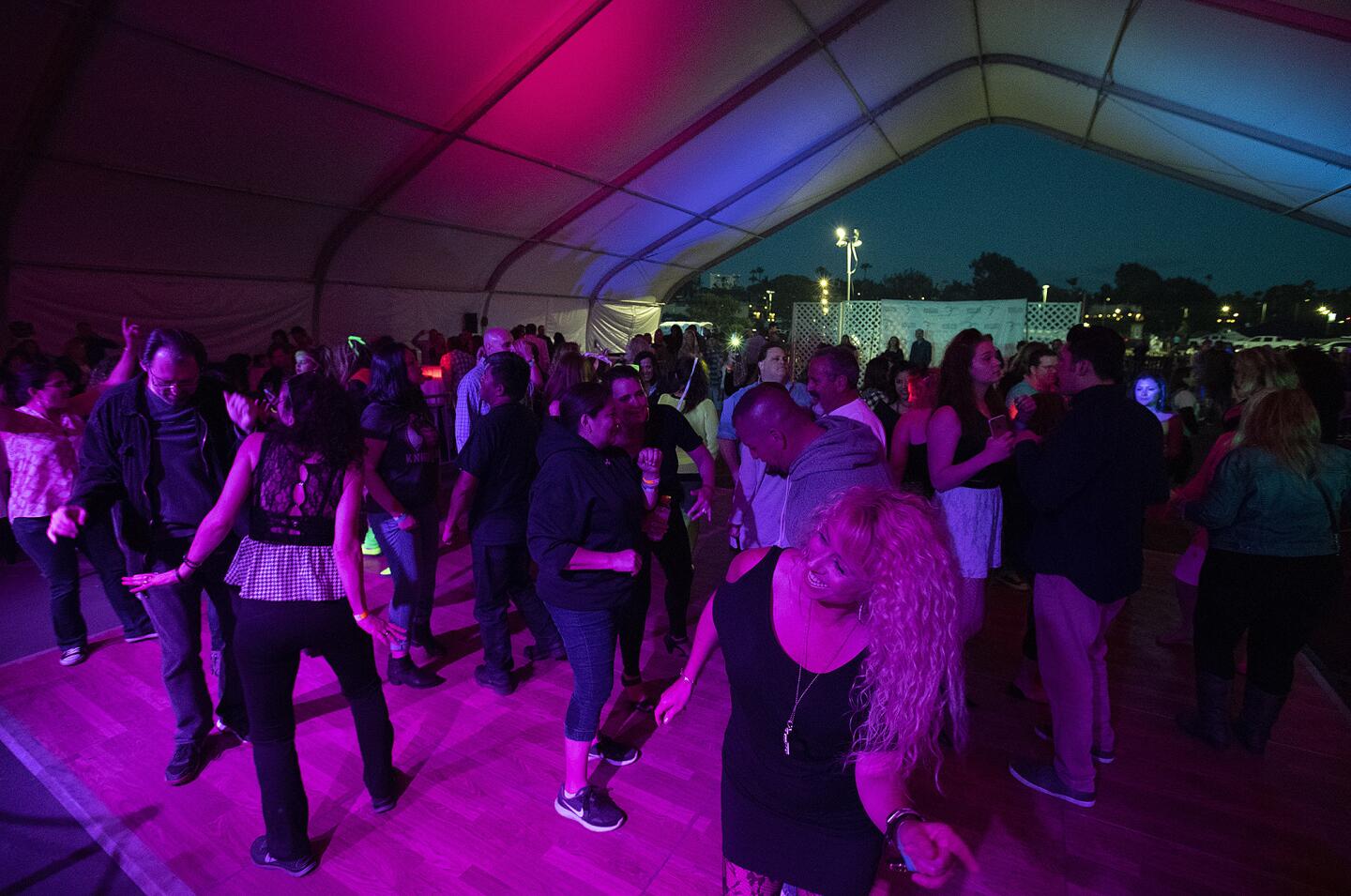Party goers dance during the Newport Dunes "80's on the Bay" on Friday, May 25.