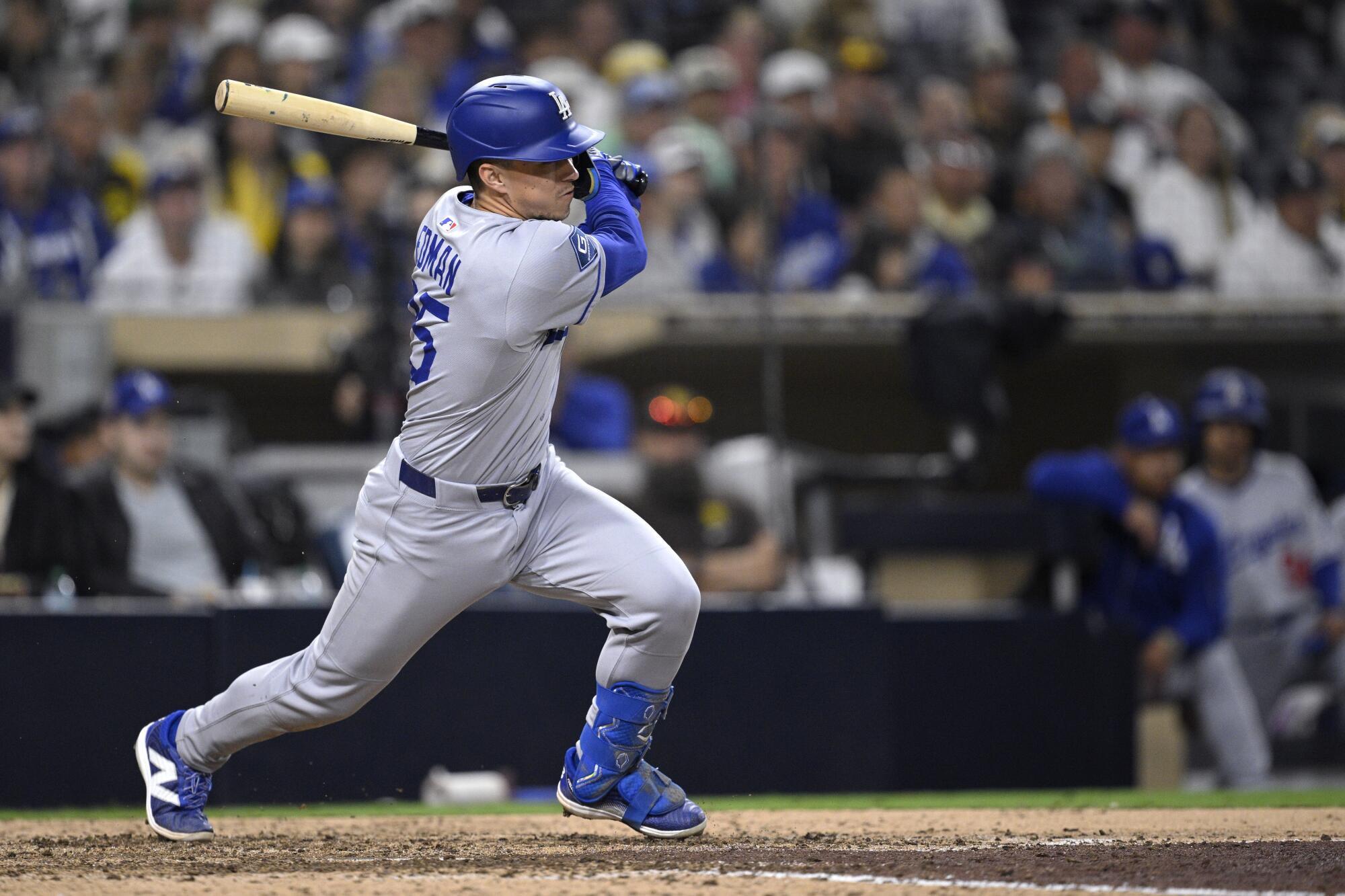 Tommy Edman hits a run-scoring single in the 10th inning of the Dodgers' 8-7 win over the San Diego Padres.