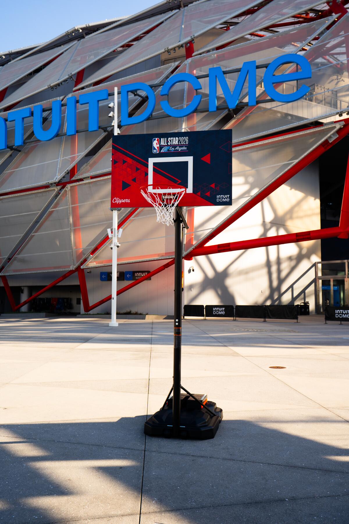 An outdoor basketball hoop stands outside Intuit Dome.