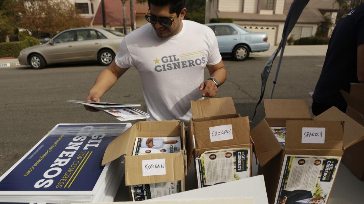 A campaign staffer for Democrat Gil Cisneros organizes translated campaign fliers for Cisneros' effort to mobilize and turn out Asian American voters in the 39th District, a majority-minority district with a large Latino population.