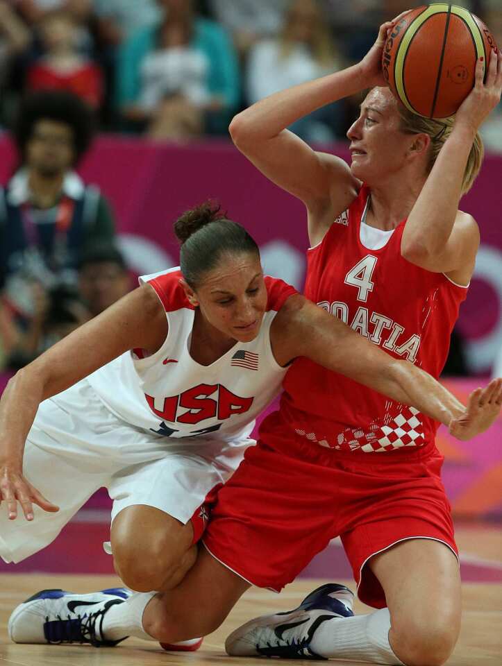 USA defender Diana Taurasi pressures Croatia's Sandra Mandir during a preliminary game at the London 2012 Olympics Basketball Arena.